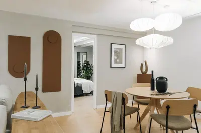 a bedroom with a large bed with gray sheets and pillows at Acatenango - 2 bedrooms in El Born in Barcelona