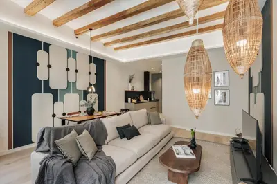a living room with a couch and a tv at Cesme - 2 bedrooms and balcony in Sant Pere in Barcelona