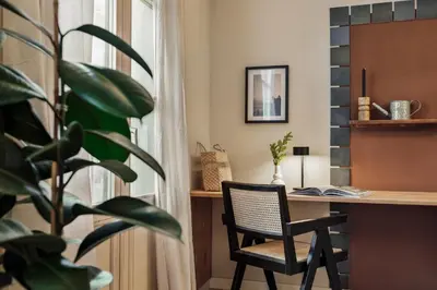 a hallway with a sink and a mirror and a table at Ipek - 2 bedrooms and balcony in Sant Pere in Barcelona