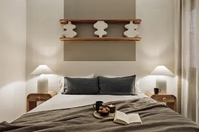 a bedroom with a bed and a table with a lamp at Niria - 2 bedrooms and balcony in Eixample Esquerra in Barcelona