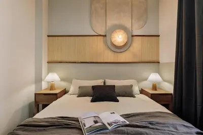 a bedroom with a bed and a chair in a room at Nal - 2 bedrooms, office and balcony in Eixample Dreta in Barcelona
