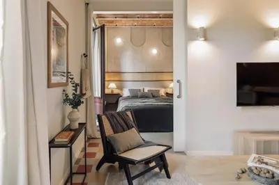 a dining room with a table and chairs and a couch at Nal - 2 bedrooms, office and balcony in Eixample Dreta in Barcelona