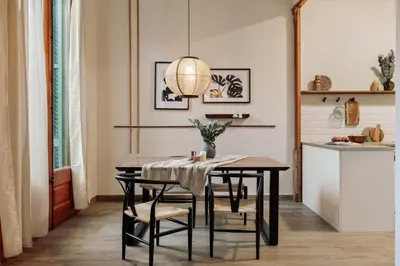 a bedroom with a bed and a chair in it at Kusku - 3 bedrooms and balcony in Eixample Dreta in Barcelona