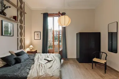 a bedroom with a bed and a window at Kusku - 3 bedrooms and balcony in Eixample Dreta in Barcelona