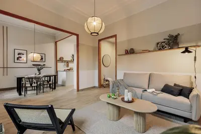 a living room with a couch and a table at Kusku - 3 bedrooms and balcony in Eixample Dreta in Barcelona