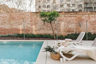 a living room with a table and a couch at Aliga - 3 bedroom and pool in Les Corts in Barcelona