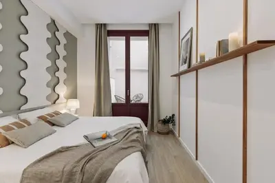 a bed with two lamps and two books on it at Cliento - 2 bedrooms and terrace in Ciutat Vella in Barcelona