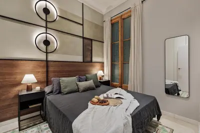 a kitchen and living room with a wooden table and a dining room at Claes - 2 bedrooms and balcony in Sant Gervasi - La Bonanova in Barcelona