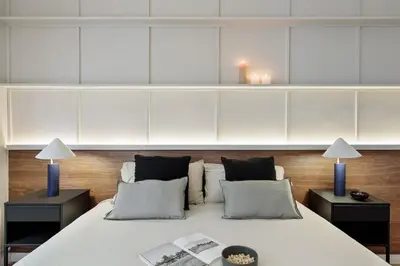 a bedroom with a white bed with black pillows at Gaudi - 3 bedrooms and terrace in Sant Gervasi in Barcelona
