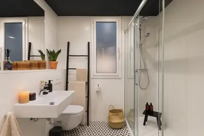 a bedroom with a bed and a table with a candle at Taoudeni - 3 bedrooms in Eixample Esquerra in Barcelona