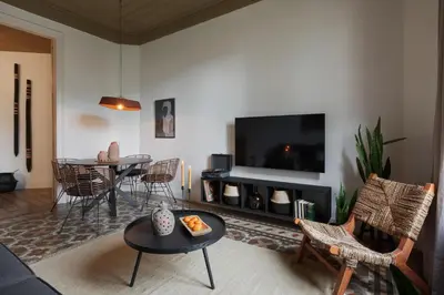 a hotel room with two beds with a bowl of fruit at Taoudeni - 3 bedrooms in Eixample Esquerra in Barcelona