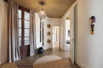 a hallway with white walls and a black door at Taoudeni - 3 bedrooms in Eixample Esquerra in Barcelona