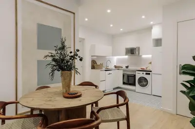 a bedroom with a large bed with two lamps at Pogerola - 2 bedrooms, balcony and terrace in Ciutat Vella in Barcelona