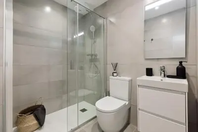 a bedroom with a large bed with two lamps at Cantone - 2 bedrooms, balcony and terrace in Ciutat Vella in Barcelona