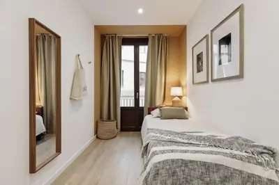 a living room with a couch and a tv at Cantone - 2 bedrooms, balcony and terrace in Ciutat Vella in Barcelona