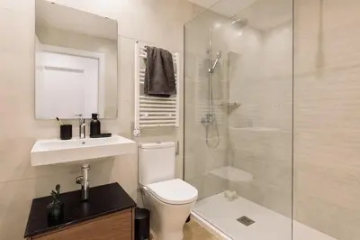 a bedroom with a bed and a desk and windows at Kline - 2 bedrooms and terrace in Sant Antoni in Barcelona