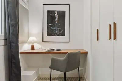 a desk in a room with a chair and a lamp at Tikal - 3 bedrooms and balcony in Sant Gervasi in Barcelona