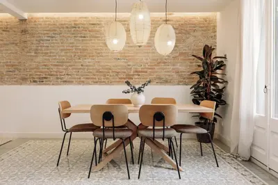 a kitchen with white cabinets and a table and chairs at Tikal - 3 bedrooms and balcony in Sant Gervasi in Barcelona