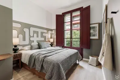 a bedroom with a large bed and a window at Llum - 1 bedroom and balcony in Sant Antoni in Barcelona