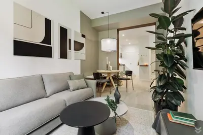 a kitchen with white cabinets and black counter tops at Llum - 1 bedroom and balcony in Sant Antoni in Barcelona