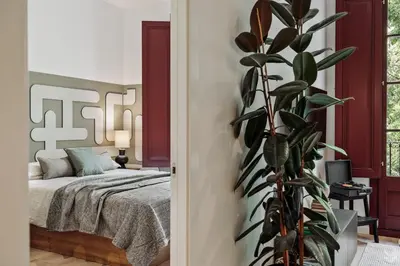 a living room with a desk and a tv on a wall at Llum - 1 bedroom and balcony in Sant Antoni in Barcelona