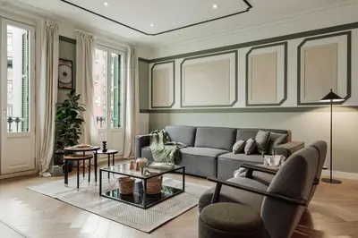 a kitchen with black cabinets and bar stools at Mavi - 2 bedrooms and balcony in Eixample Dreta in Barcelona