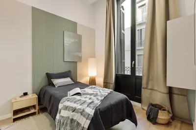a kitchen and living room with a couch and a table at Baronissi - 2 bedrooms and terrace in Ciutat Vella in Barcelona