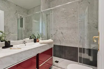 a bedroom with a bed with a book on it at Edera - 3 bedrooms and balcony in Eixample Dreta in Barcelona