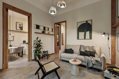 a living room with a couch and a table at Ada - 2 bedrooms and balcony in Eixample Dreta in Barcelona