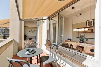 a room with a balcony with a table and chairs at Solea - 3 bedrooms and balcony in Eixample Dreta in Barcelona