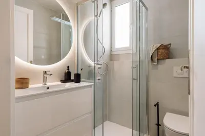 a bedroom with a large bed and a table at Solea - 3 bedrooms and balcony in Eixample Dreta in Barcelona