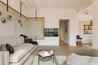 a kitchen with white cabinets and a black stool at Solea - 3 bedrooms and balcony in Eixample Dreta in Barcelona
