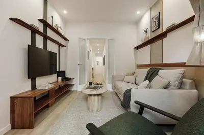 a living room with a couch and a tv at Kayra - 2 bedrooms and terrace in La Sagrada Familia in Barcelona