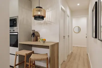 a living room with a couch and a chair at Kayra - 2 bedrooms and terrace in La Sagrada Familia in Barcelona