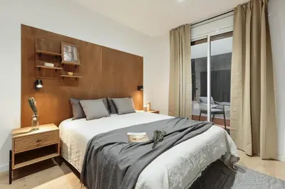 a dining room with a wooden table and chairs at Arlet - 4 bedrooms in Eixample Dreta in Barcelona