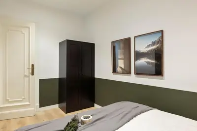 a bedroom with a large bed with two lamps at Arlet - 4 bedrooms in Eixample Dreta in Barcelona