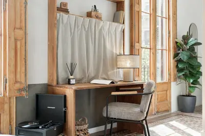 a kitchen and living room with a table and a couch at Serre - Studio in Eixample Dreta in Barcelona