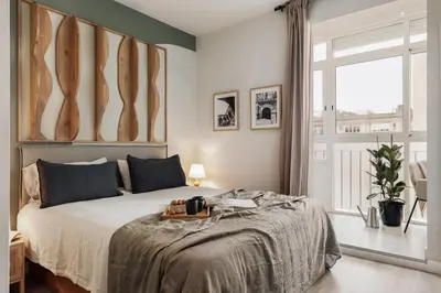 a living room with a couch and a table at Freso - Studio in Eixample Esquerra in Barcelona