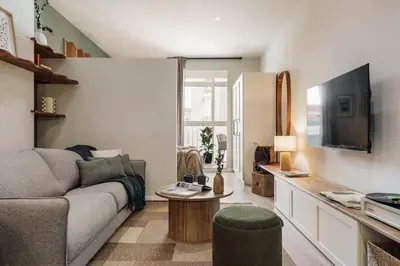 a living room with a table and chairs and a couch at Freso - Studio in Eixample Esquerra in Barcelona