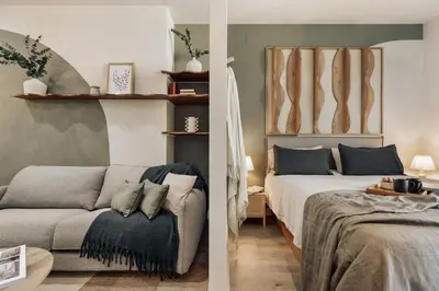 a kitchen with white cabinets and a washer and dryer at Freso - Studio in Eixample Esquerra in Barcelona