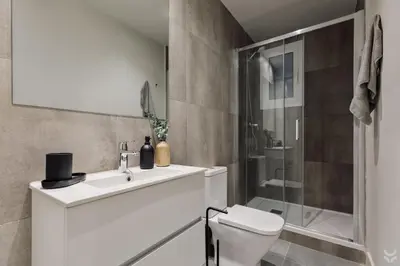 a bedroom with a bed and a desk and a chair at Sariyer - 2 bedrooms and balcony in El Putxet in Barcelona