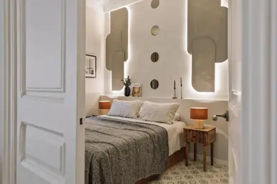 a bedroom with a bed and a desk and a chair at Cumulus - 2 bedrooms and balcony in Vila de Gràcia in Barcelona