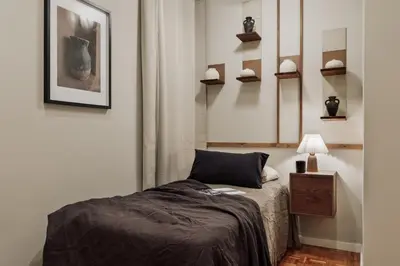 a bedroom with a large bed with a striped headboard at Amani - 3 bedrooms in Vila de Gràcia in Barcelona