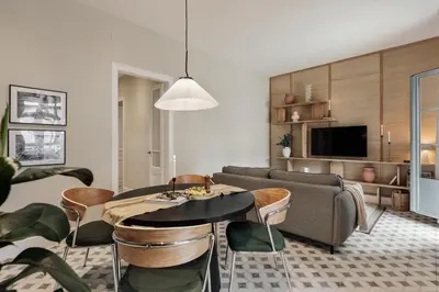 a hallway with a mirror and a black dresser at Baru - 2 bedrooms and terrace in Eixample Esquerra in Barcelona