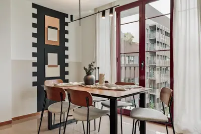 a bedroom with a large bed with a desk and a desk at Kabatas - 3 bedrooms and patio in Eixample Dreta in Barcelona