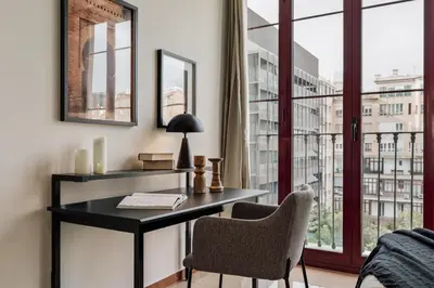 a living room with a tv and a bedroom at Kabatas - 3 bedrooms and patio in Eixample Dreta in Barcelona