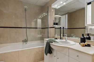 a bedroom with a mirror next to a bed at Kabatas - 3 bedrooms and patio in Eixample Dreta in Barcelona