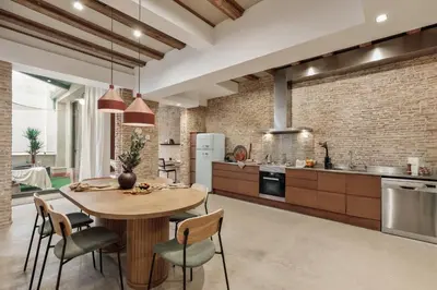a living room with a couch and a chair at Galata - 3 bedrooms and terrace in Vila de Gràcia in Barcelona