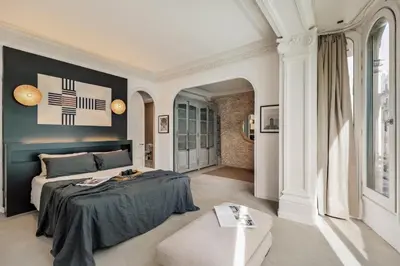 an open kitchen with a wooden table and chairs at Galata - 3 bedrooms and terrace in Vila de Gràcia in Barcelona
