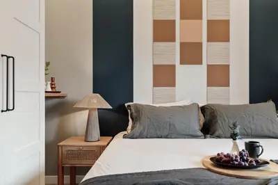 a bedroom with a bed with a large painting on the wall at Davut - 3 bedrooms and office in Eixample Esquerra in Barcelona